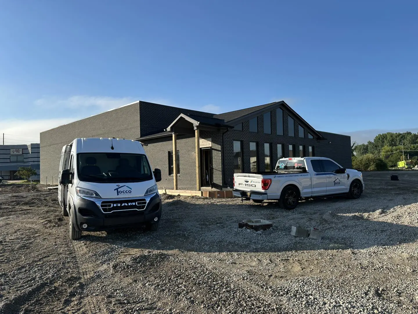 Construction site with van and pickup truck