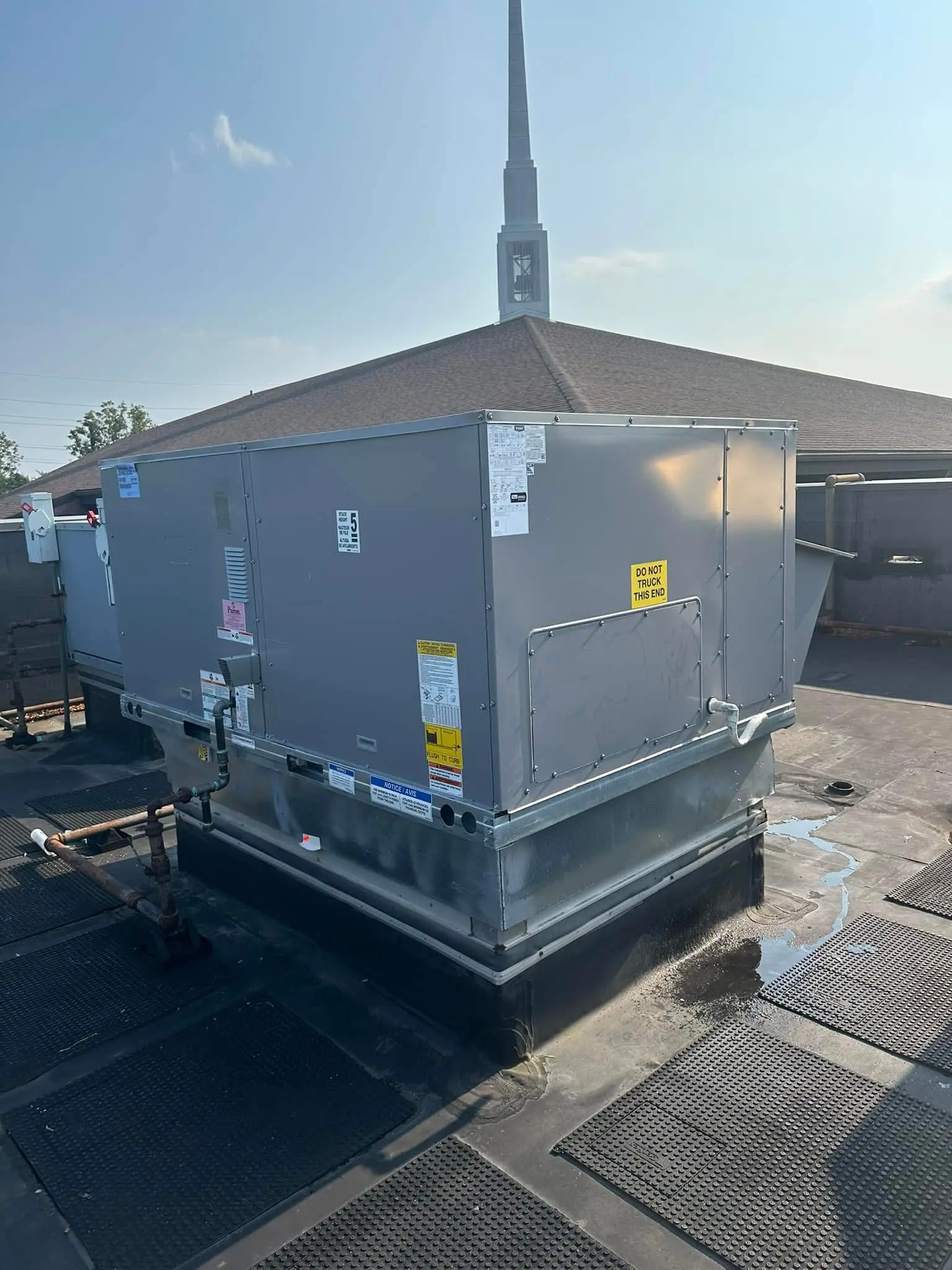 Rooftop HVAC unit near building steeple