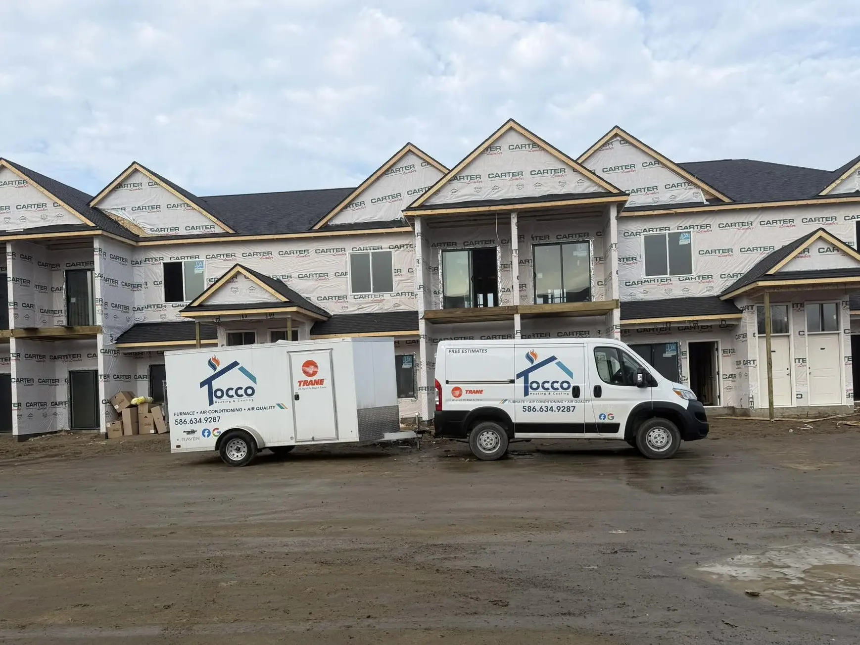 Townhouses under construction with company vehicles
